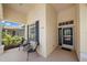 Welcoming front porch with seating area, and a view of the front door with sidelight, transom, and sidelight window at 750 Anna Hope Ln, Osprey, FL 34229