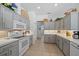 Charming kitchen features gray cabinetry, tile flooring, modern appliances, and ample counter space at 750 Anna Hope Ln, Osprey, FL 34229