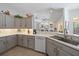 Open concept kitchen boasts gray cabinets, sleek countertops, and seamless flow to the living area at 750 Anna Hope Ln, Osprey, FL 34229