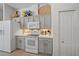Well-appointed kitchen with gray cabinetry, modern white appliances, and functional layout at 750 Anna Hope Ln, Osprey, FL 34229