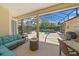 Screened in lanai with turquoise sofa, ceiling fan and view of the private pool at 750 Anna Hope Ln, Osprey, FL 34229