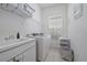 Clean laundry room featuring a washer, dryer, sink, and ample shelving at 750 Anna Hope Ln, Osprey, FL 34229