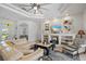 Spacious living room with a plush sofa, built-in shelving, and views into the kitchen and dining areas at 750 Anna Hope Ln, Osprey, FL 34229