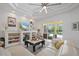 Cozy living room featuring built-in shelving, a comfortable sofa, and sliding glass doors to the outdoor pool area at 750 Anna Hope Ln, Osprey, FL 34229