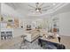 Bright and airy living room with a large sectional sofa, decorative ceiling, and open floor plan at 750 Anna Hope Ln, Osprey, FL 34229