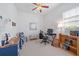 Bright office space with a wood bookshelf, blue desk, and a large window at 750 Anna Hope Ln, Osprey, FL 34229