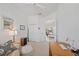 Bright office space with a sofa and view to a sunroom and pool at 750 Anna Hope Ln, Osprey, FL 34229