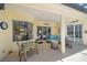 Comfortable patio with seating area, table, and charming decor, perfect for outdoor relaxation and dining at 750 Anna Hope Ln, Osprey, FL 34229