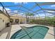 Charming pool area with a screened-in lanai, outdoor seating, and meticulously maintained landscaping at 750 Anna Hope Ln, Osprey, FL 34229