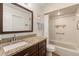 Bathroom features granite countertops, a shower-tub combo, and accessibility grab bars at 7907 4Th W Ave # 7907, Bradenton, FL 34209