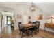 Dining area with modern lighting fixture, hardwood floors, and view of adjacent rooms at 7907 4Th W Ave # 7907, Bradenton, FL 34209