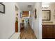 Inviting hallway with wood-look flooring, leading to the bathroom and showcasing the house's layout at 7907 4Th W Ave # 7907, Bradenton, FL 34209