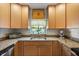 Bright kitchen featuring granite countertops, stainless steel sink, and neutral-tone cabinetry at 7907 4Th W Ave # 7907, Bradenton, FL 34209