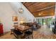 Open-concept living and dining area with wood-clad vaulted ceilings and an abundance of natural light at 7907 4Th W Ave # 7907, Bradenton, FL 34209