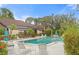 Community pool featuring mature landscaping, lounge chairs and tables, and a clear blue swimming pool at 7907 4Th W Ave # 7907, Bradenton, FL 34209