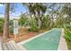 Outdoor recreation area with shuffleboard court, bench seating, and lush greenery at 7907 4Th W Ave # 7907, Bradenton, FL 34209
