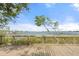 Enjoy serene water views from a wooden deck, framed by beautiful greenery and clear skies at 7907 4Th W Ave # 7907, Bradenton, FL 34209