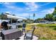 Outdoor space with a fire pit, seating area, and covered boat storage at 997 28Th Avenue E Dr, Bradenton, FL 34208