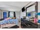 Bright bedroom featuring a modern dresser with mirror, TV, and natural light at 997 28Th Avenue E Dr, Bradenton, FL 34208