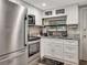 Modern kitchen with stainless steel appliances and white cabinetry, perfect for culinary enthusiasts at 997 28Th Avenue E Dr, Bradenton, FL 34208