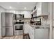 This is a kitchen with stainless steel appliances and white cabinets at 997 28Th Avenue E Dr, Bradenton, FL 34208