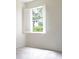 Bright bedroom featuring a window overlooking lush trees and neutral carpet at 104 Park Trace Blvd, Osprey, FL 34229