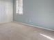 Light-filled bedroom features neutral carpet, blue walls, closet, and natural light at 104 Park Trace Blvd, Osprey, FL 34229