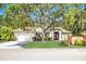 Charming single-story home with a well-manicured lawn and mature trees shading the entrance at 104 Park Trace Blvd, Osprey, FL 34229