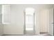 Bright hallway with a view of a bathroom featuring natural light and a soothing design at 104 Park Trace Blvd, Osprey, FL 34229