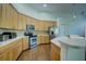 Well-equipped kitchen with wooden cabinets, stainless steel appliances, and a center island with countertop seating at 104 Park Trace Blvd, Osprey, FL 34229