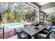 Spacious screened-in lanai with a pool, outdoor dining area, grill and lush landscaping at 104 Park Trace Blvd, Osprey, FL 34229