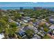 An elevated shot reveals the property's location amidst a mix of houses, trees, and the stunning backdrop of the bay at 1140 Oak Ne St, St Petersburg, FL 33701
