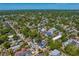 A vibrant neighborhood is captured from above, highlighting the mature trees and residential architecture of the community at 1140 Oak Ne St, St Petersburg, FL 33701
