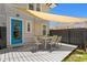 Backyard deck featuring an outdoor dining set, blue door and shaded with nice backyard at 1140 Oak Ne St, St Petersburg, FL 33701
