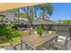 Backyard deck featuring an outdoor dining set, grassy backyard, firepit and chairs at 1140 Oak Ne St, St Petersburg, FL 33701