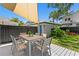 Backyard deck featuring an outdoor dining set, grassy backyard, and black fence at 1140 Oak Ne St, St Petersburg, FL 33701