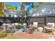 Brick paved backyard patio with outdoor seating and a fire pit at 1140 Oak Ne St, St Petersburg, FL 33701