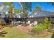 Well-manicured backyard features a brick patio, cozy seating, and lush landscaping at 1140 Oak Ne St, St Petersburg, FL 33701
