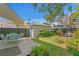 Inviting backyard with deck, dining area, lush lawn, garden, and privacy fence at 1140 Oak Ne St, St Petersburg, FL 33701