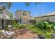 Charming backyard with a lush lawn, brick patio, and inviting seating area at 1140 Oak Ne St, St Petersburg, FL 33701