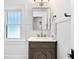 Stylish bathroom with vanity cabinet, white marble countertop and unique window at 1140 Oak Ne St, St Petersburg, FL 33701
