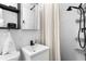 Modern bathroom with shower, sleek fixtures, white tiles, and open shelving for storage at 1140 Oak Ne St, St Petersburg, FL 33701