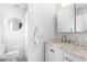 Clean, updated bathroom with a marble vanity top and round mirror at 1140 Oak Ne St, St Petersburg, FL 33701