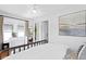Sunlit bedroom featuring hardwood floors, white walls, and a unique art piece on the wall at 1140 Oak Ne St, St Petersburg, FL 33701