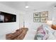 Spacious bedroom with mounted TV, artwork, and ceiling fan at 1140 Oak Ne St, St Petersburg, FL 33701