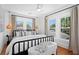 Bright bedroom featuring hardwood floors, large windows, and stylish black metal bedframe at 1140 Oak Ne St, St Petersburg, FL 33701