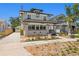 Charming two-story home featuring a brick foundation, inviting front porch, and well-manicured landscaping at 1140 Oak Ne St, St Petersburg, FL 33701