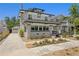Charming two-story home featuring a brick facade, black accents, landscaped garden and a long driveway to the garage at 1140 Oak Ne St, St Petersburg, FL 33701