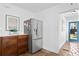 Modern kitchen includes stainless steel refrigerator and custom wooden storage with access to a bright blue door at 1140 Oak Ne St, St Petersburg, FL 33701