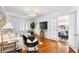 Bright living room featuring hardwood floors, large windows with shutters, and an open layout at 1140 Oak Ne St, St Petersburg, FL 33701